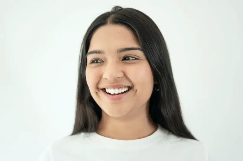 Woman smiling after getting her teeth cleaned